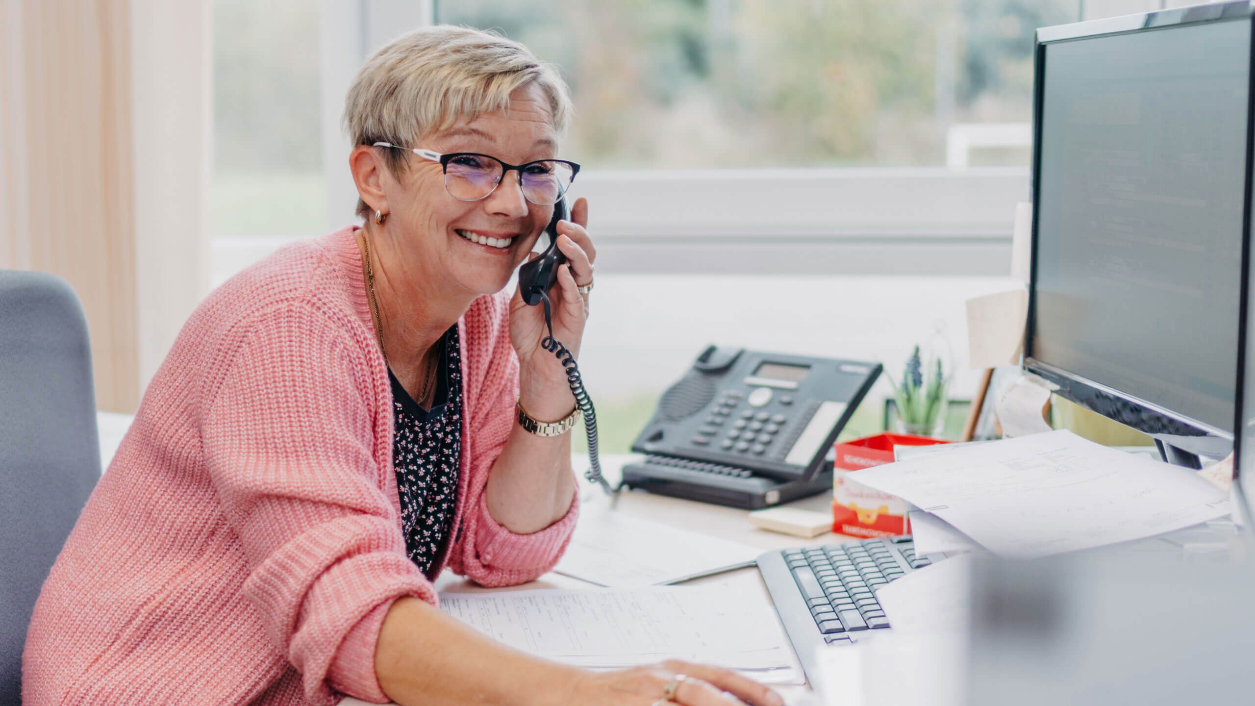 Angestellte am Standort Osterburg lächelt bei der Arbeit im Büro